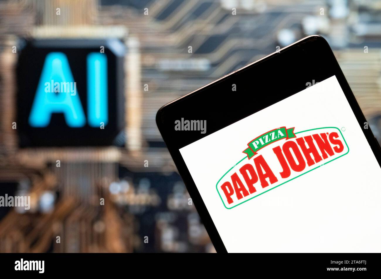 Dans cette illustration photo, le logo de la franchise de pizzeria américaine Papa John's Pizza (Nasdaq : PZZA) vu affiché sur un smartphone avec une puce d'intelligence artificielle (IA) et un symbole en arrière-plan. Banque D'Images