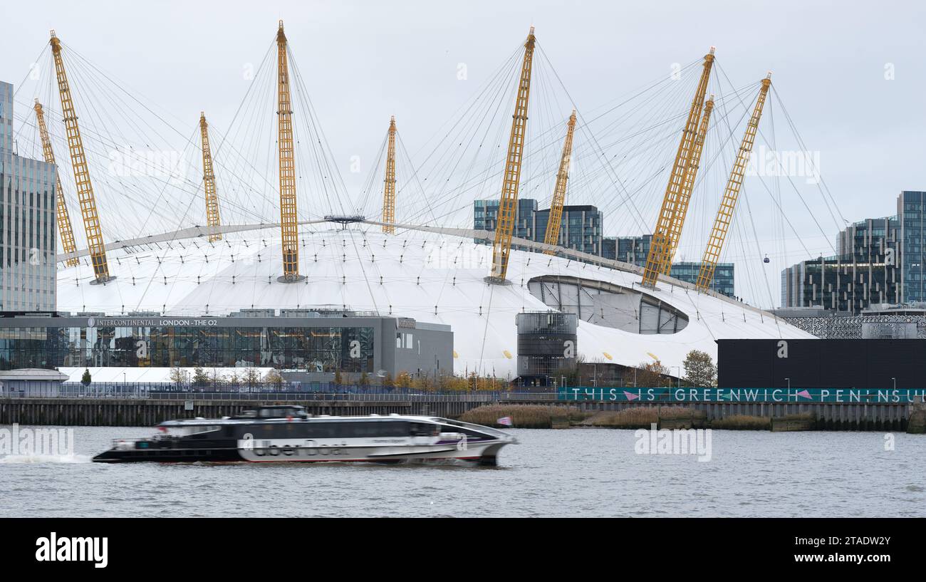Un bateau de bus fluvial Uber court devant le bâtiment du millénaire O2 Arena sur une rive de la Tamise à Greenwhich Peninsula, Londres, Angleterre. Banque D'Images