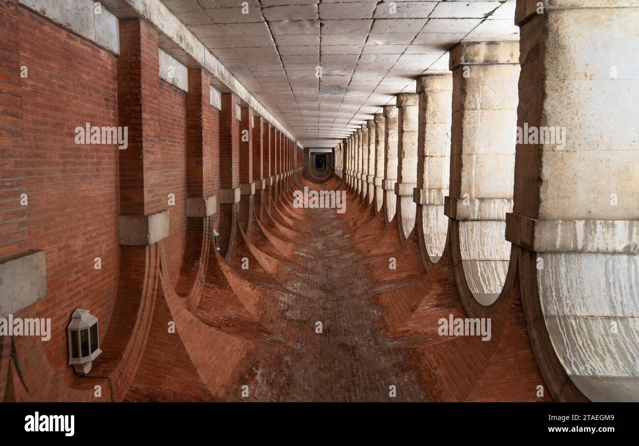 Couloir symétrique avec arches et colonnes inversées dans le palais royal d'Aranjuez. Madrid. Espagne. Banque D'Images