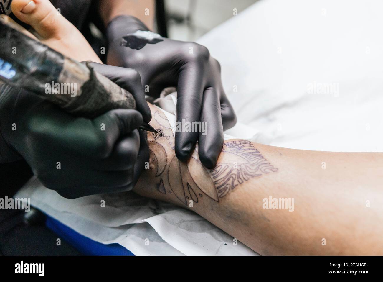 gros plan de tatouage sur le pied d'un client se faisant tatouer Banque D'Images