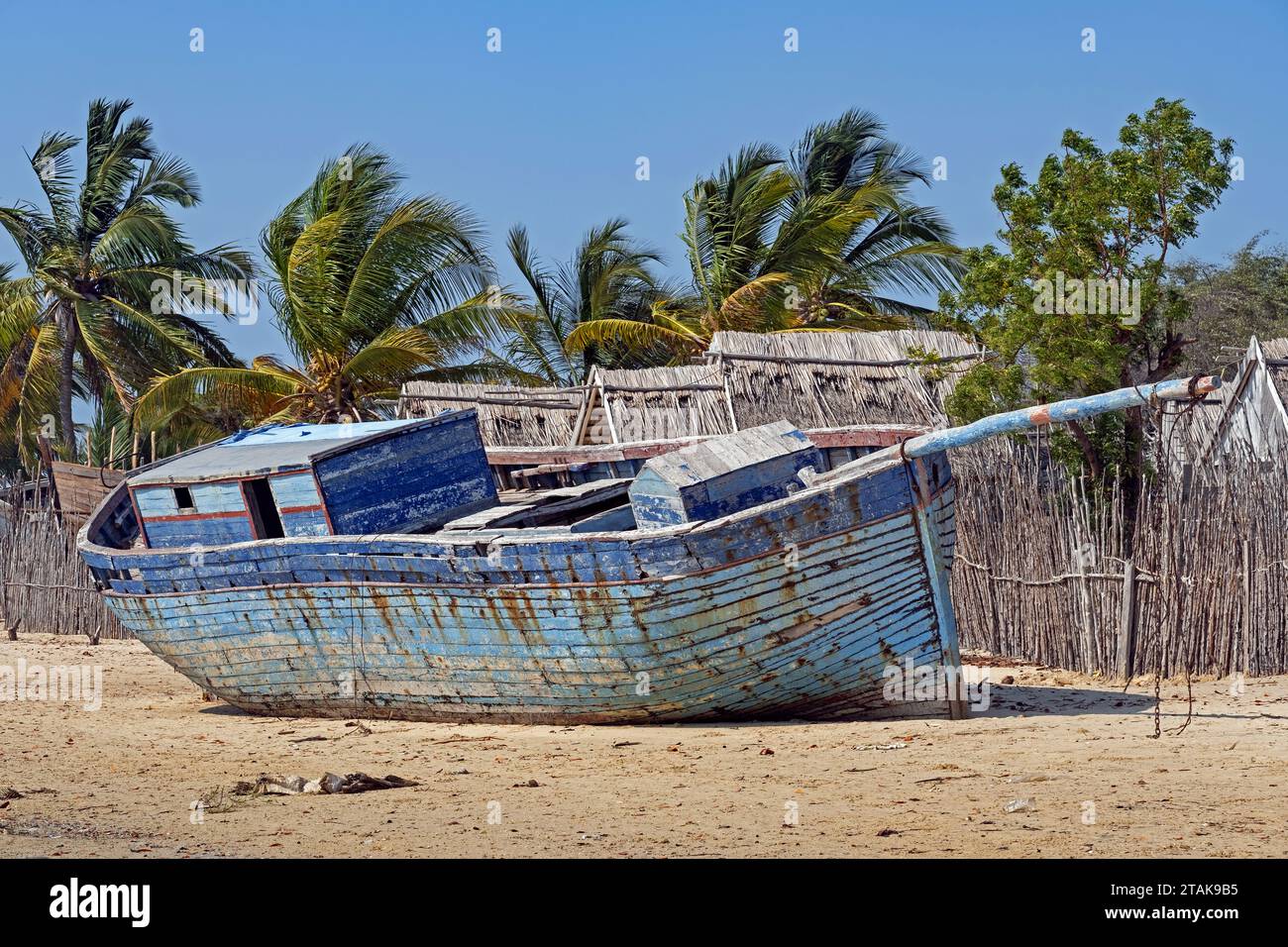 Vieux bateau de pêche en bois bleu sur la plage de sable au village côtier Belo sur Mer, district de Morondava, région de Menabe, Madagascar Banque D'Images