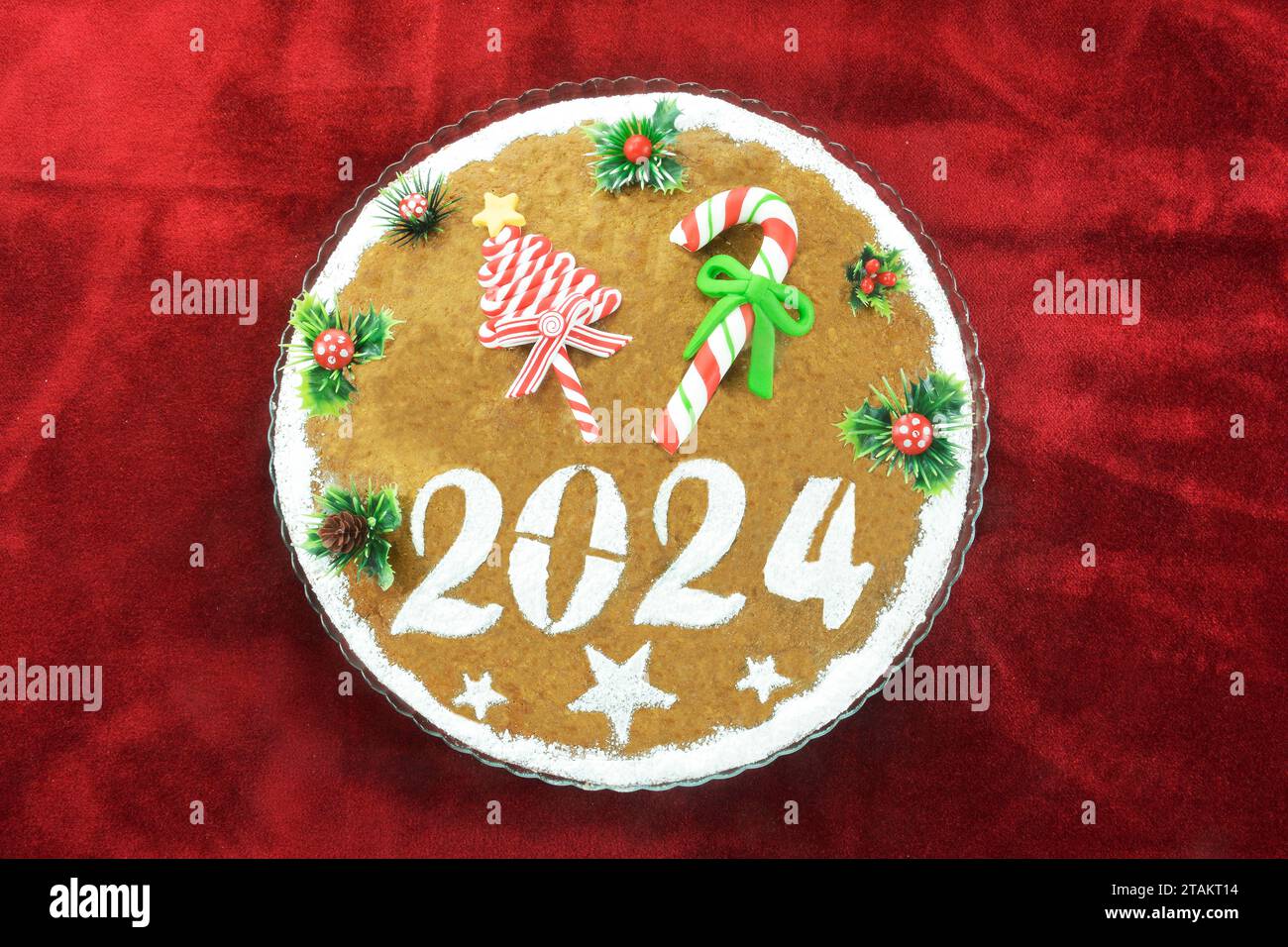 Gâteau du nouvel an, connu sous le nom de vasilopita, pour 2024 sur nappe en velours rouge Banque D'Images