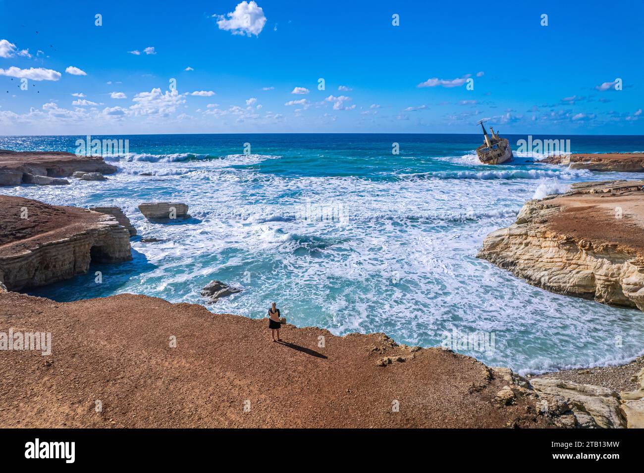 Une personne au sommet d'un rivage rocheux, regardant vers le site historique de l'épave Edro III à Chypre Banque D'Images