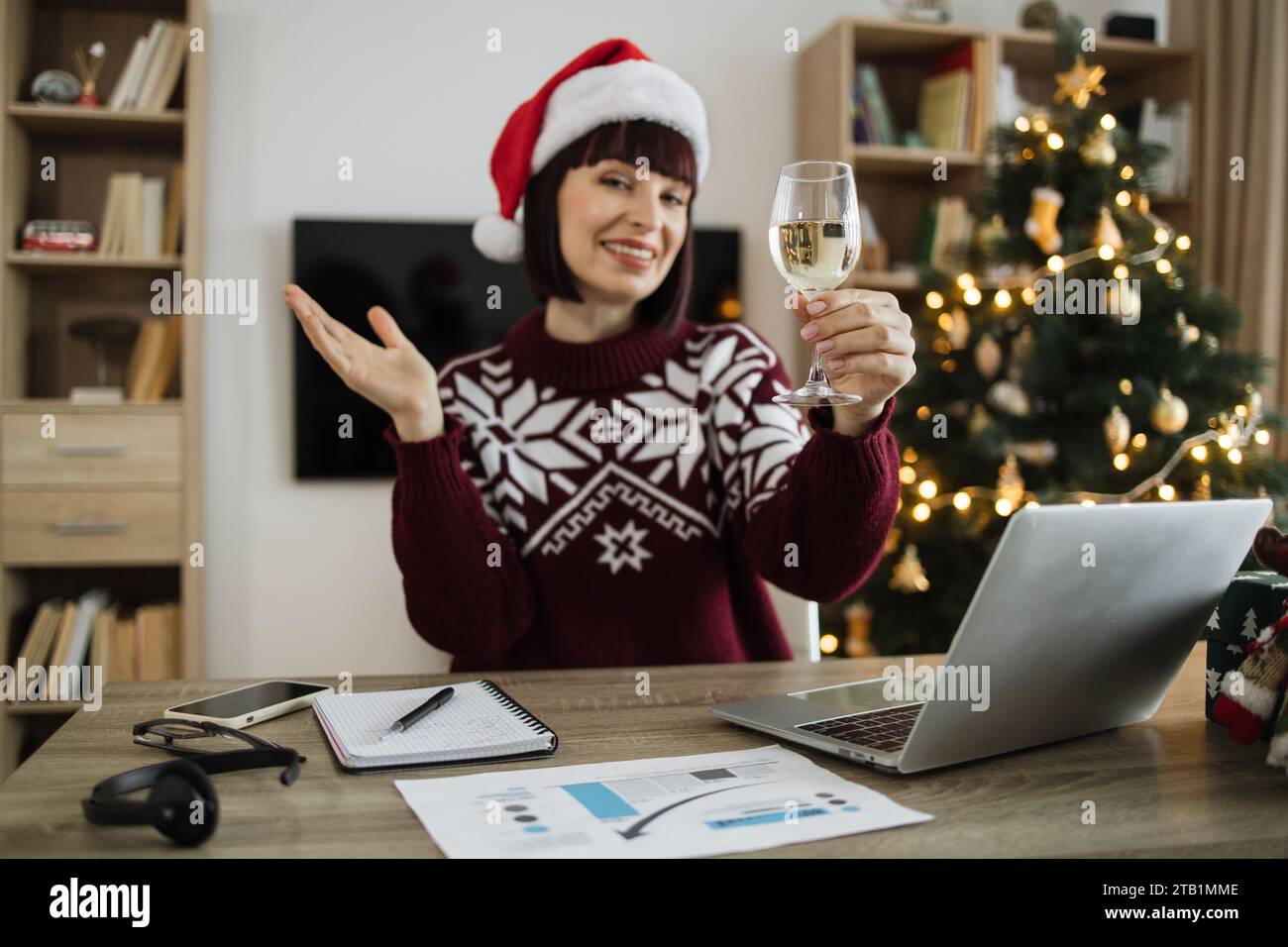 Femme tenant le verre avec du champagne regardant la caméra, saluant collègue Banque D'Images