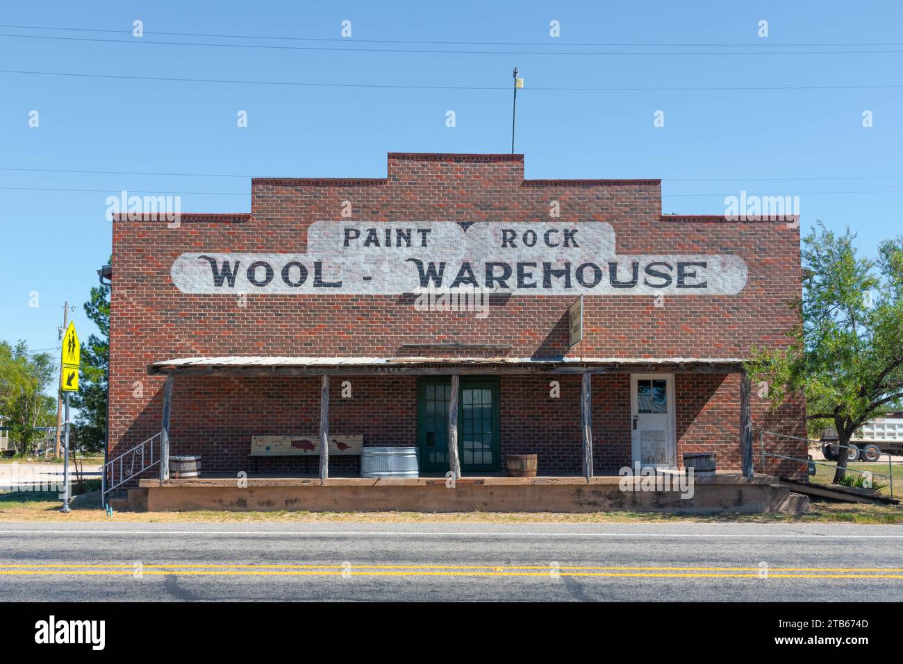 Bâtiment en brique rouge avec fausse façade, panneau peint sur la façade dit, entrepôt de laine de roche de peinture, Paint Rock Texas, comté de Concho, Texas, États-Unis. Banque D'Images