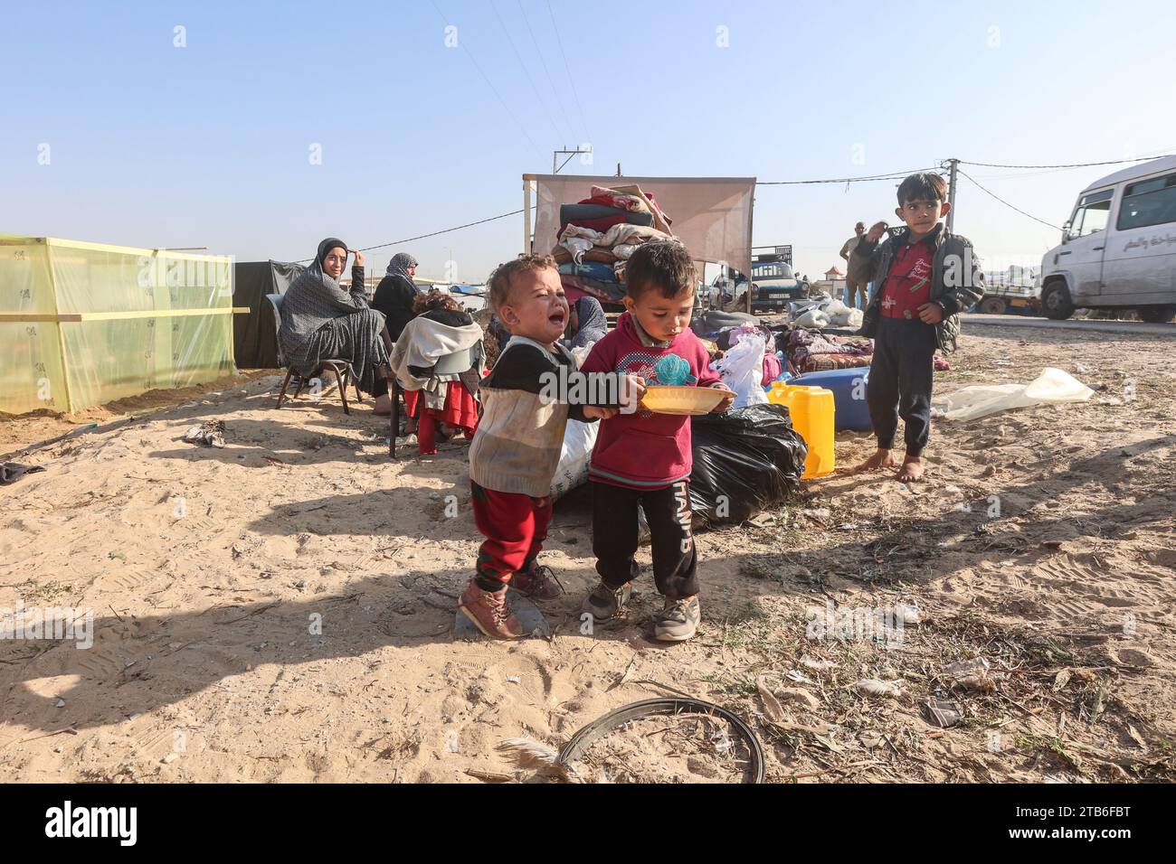 Gaza, Palestine. 04 décembre 2023. Les Palestiniens déplacés qui ont fui Khan Yunis sont assis avec leurs affaires devant des abris de fortune à Rafah, dans le sud de la bande de Gaza, au milieu des combats continus entre Israël et le groupe militant Hamas. Israël a étendu son offensive contre les militants du Hamas à Gaza assiégée, alors que la préoccupation internationale s ' intensifiait face à l ' augmentation du nombre de morts parmi les civils dans une guerre déclenchée par les attaques d ' octobre 7. (Photo Ahmed Zakot/SOPA Images/Sipa USA) crédit : SIPA USA/Alamy Live News Banque D'Images