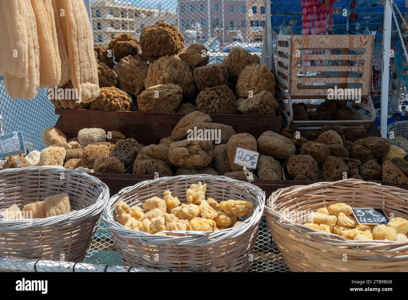Éponge de mer naturelle à vendre avec étiquette de prix au banc de magasin extérieur en Grèce. Pile d'éponge organique sèche entière ou en morceaux. Bain, spa, soins de santé. Banque D'Images