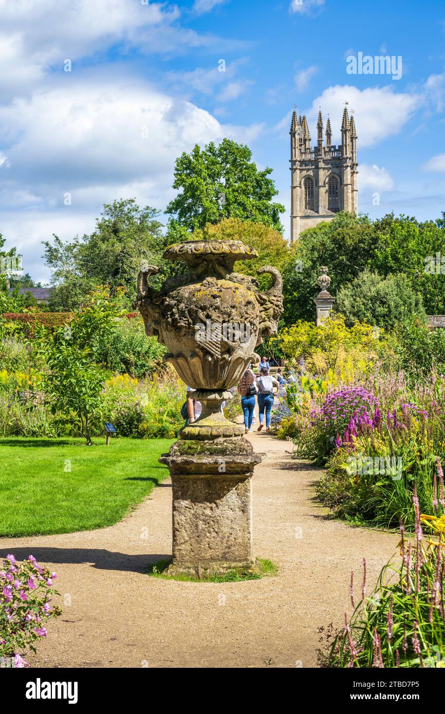 Urne en pierre ornée dans le jardin botanique d'Oxford, avec Magdalen Tower en arrière-plan dans le centre-ville d'Oxford, Oxfordshire, Angleterre, Royaume-Uni Banque D'Images