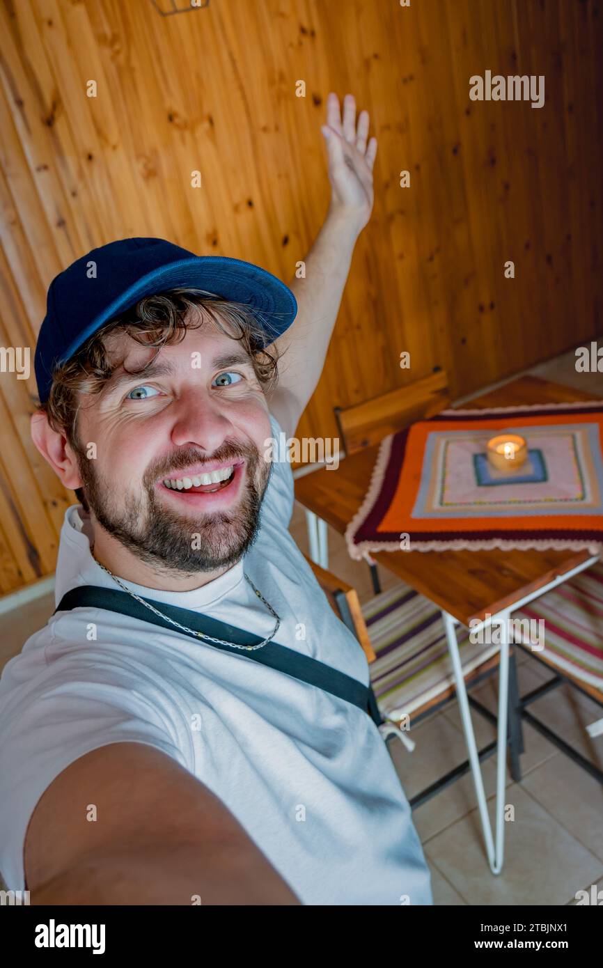 Selfie d'un jeune touriste avec une casquette, entrant dans son appartement temporaire. Banque D'Images