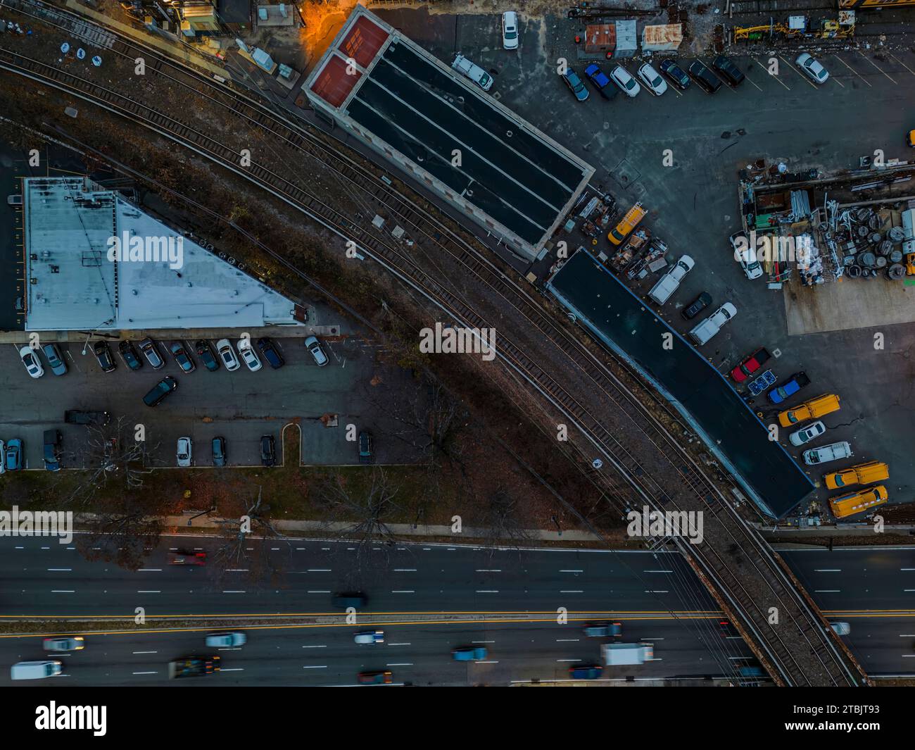 Un parking animé situé à côté d'une autoroute très fréquentée, plein de voitures et d'autres véhicules Banque D'Images