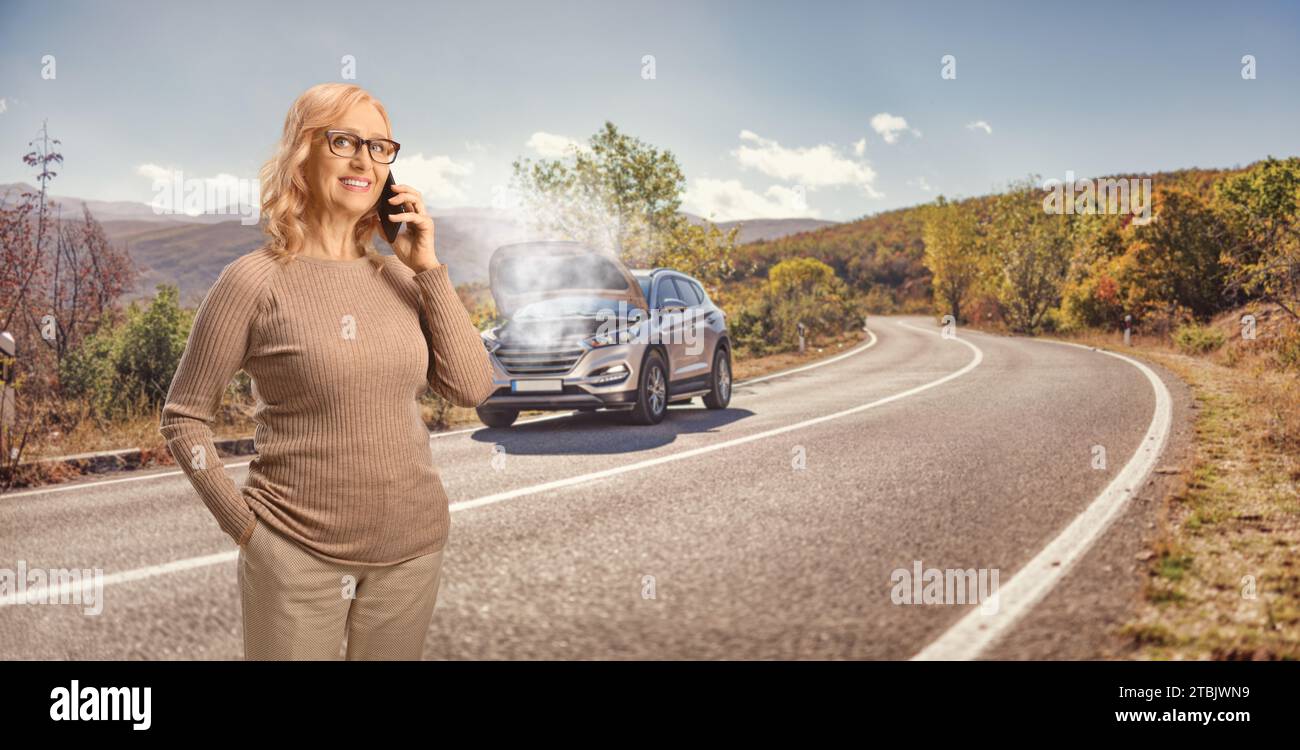 Femme conductrice avec un problème de voiture appelant une société de service de voiture sur une route ouverte Banque D'Images