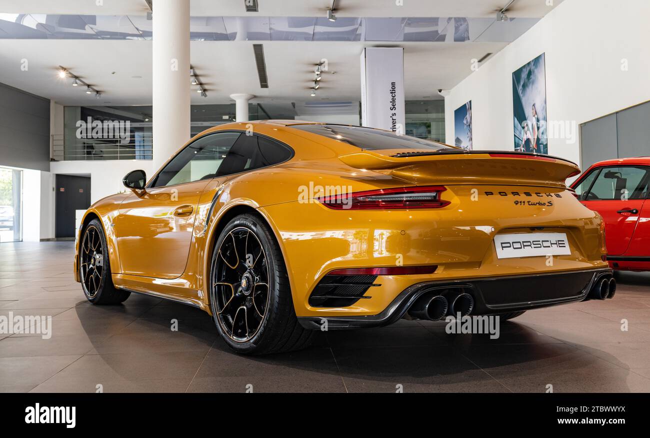 Photo d'une Porsche 911 Turbo S orange à l'intérieur d'une concession Banque D'Images