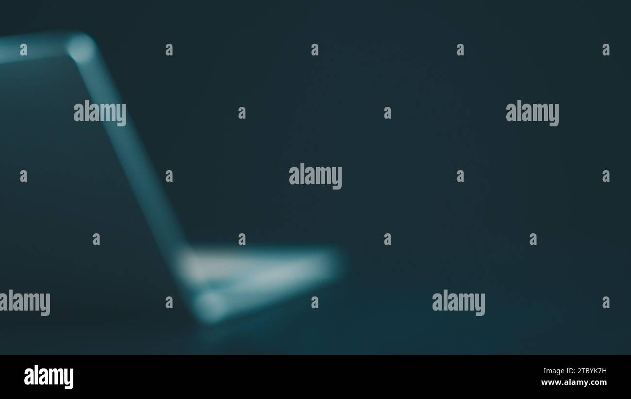 Arrière-plan abstrait, affaires et technologie fond d'ordinateur flou, vue latérale de l'ordinateur placé sur fond sombre avec espace de copie. Banque D'Images