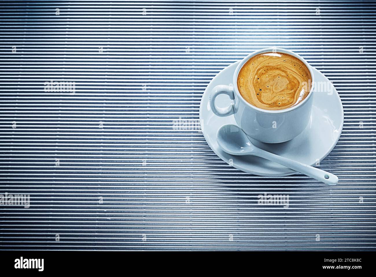 Tasse en céramique de soucoupe à café forte cuillère à café sur fond rayé Banque D'Images