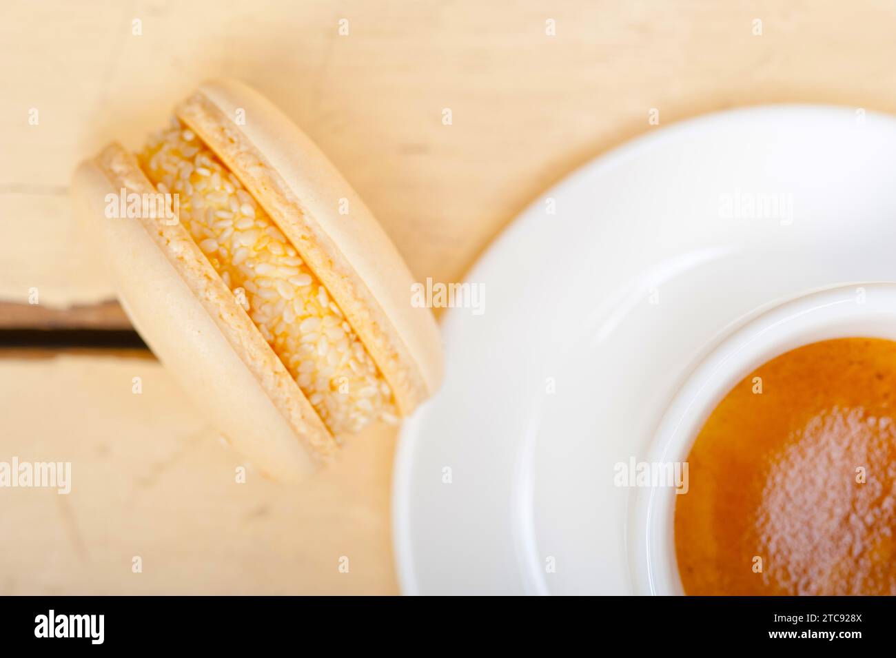 Macarons colorés avec café expresso sur table en bois blanc Banque D'Images