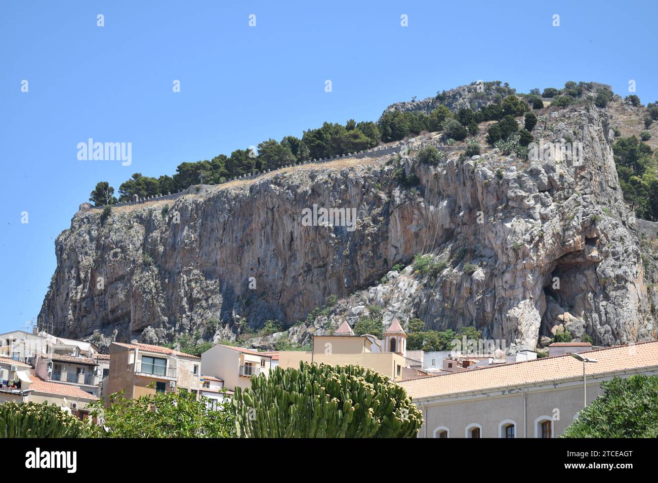 Vue sur le parc Rocca di Cefalù au sommet de la montagne derrière les maisons de la ville côtière de Cefalù Banque D'Images