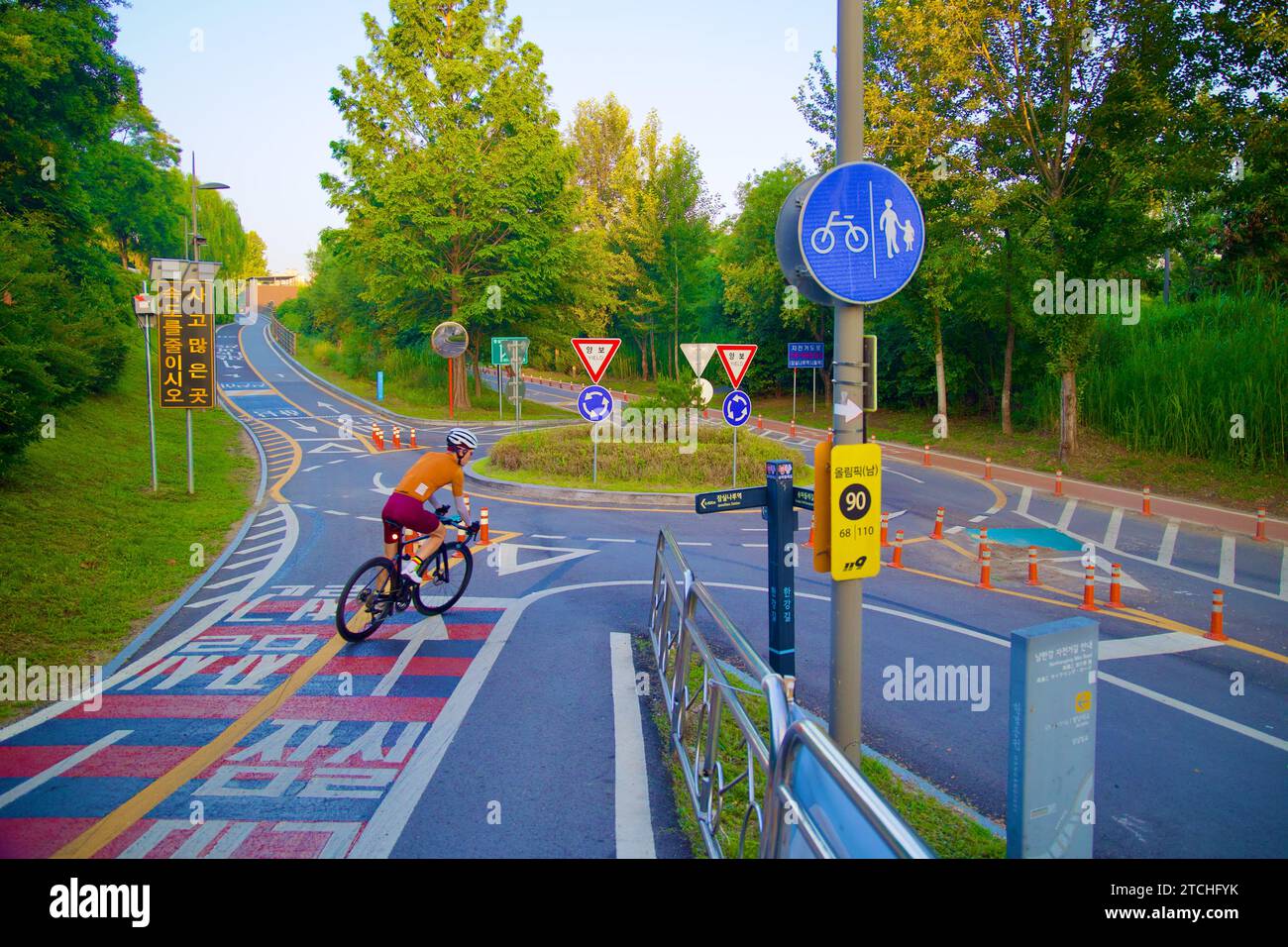 Séoul, Corée du Sud - 2 juin 2023 : au niveau de la rue, un cycliste sur un vélo de route est capturé sur le point d'entrer dans un rond-point, illustrant le cyclisme actif Banque D'Images