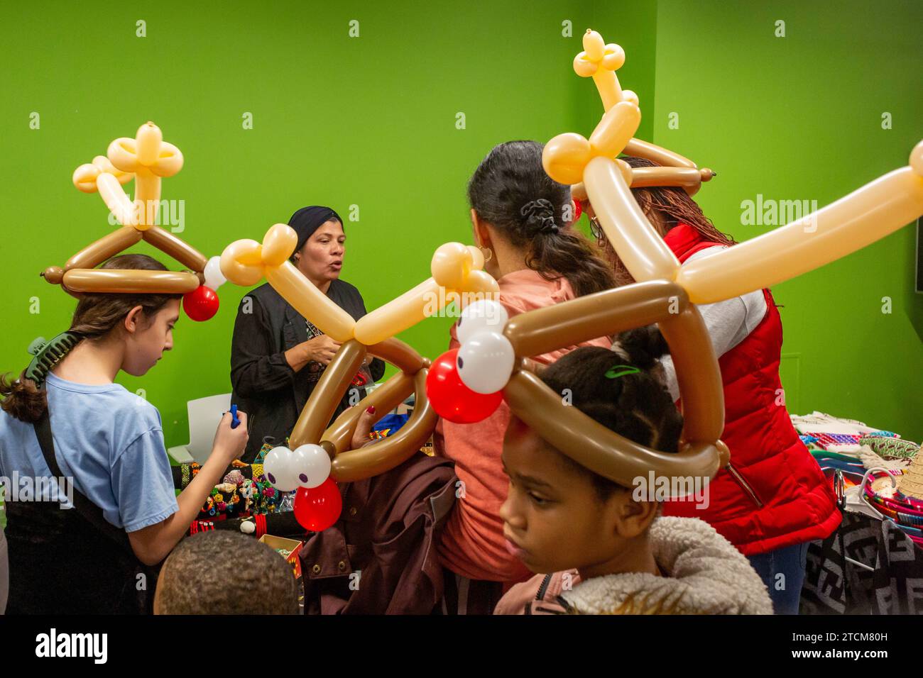 Detroit, Michigan - le Southwest Detroit Holiday Fest, dans le quartier mexicain-américain de la ville. Les enfants portaient des ballons en forme de renne. Banque D'Images
