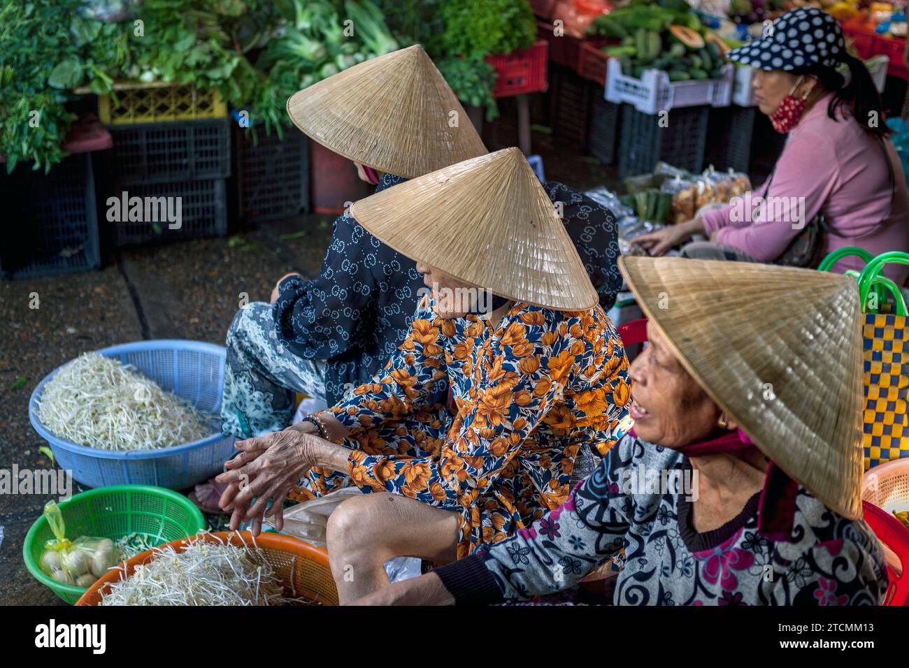 Femmes portant des chapeaux de paille traditionnels - non la - au marché de Hoi an, Vietnam Banque D'Images