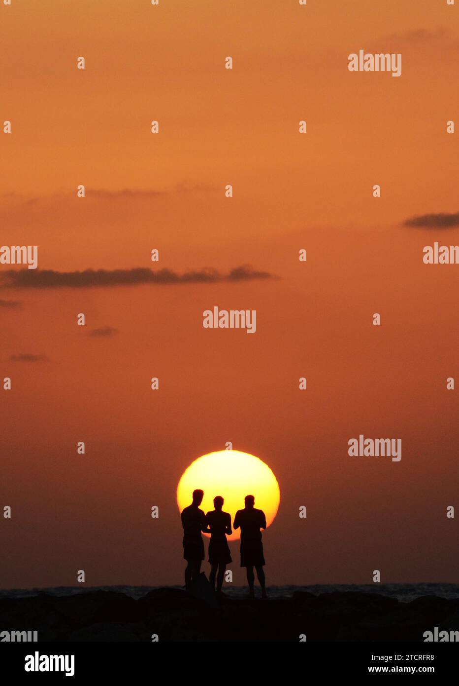 Les amis apprécient le magnifique coucher de soleil sur la plage de tel-Aviv, Israël. Banque D'Images