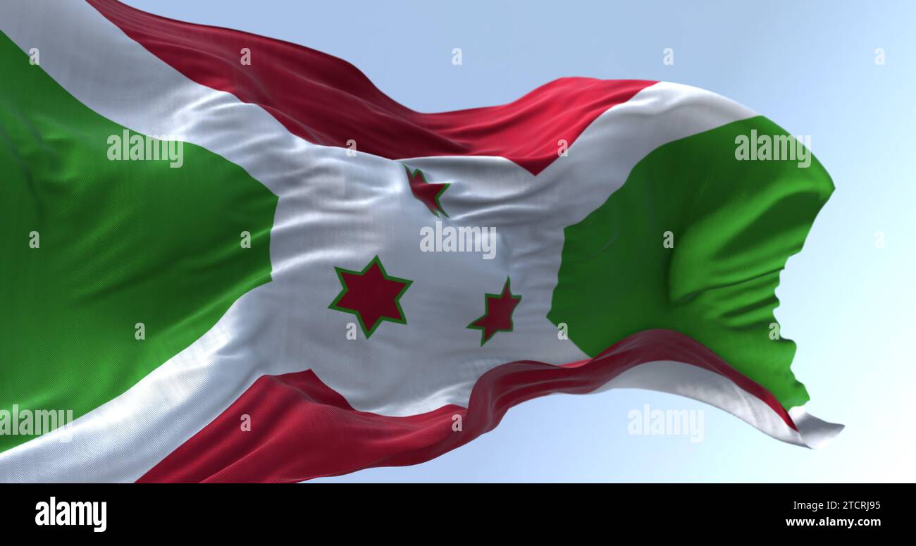 Drapeau national du Burundi brandissant par temps clair. Croix diagonale blanche se divisant en sections rouge et verte, trois étoiles vertes au centre. 3d illustr Banque D'Images