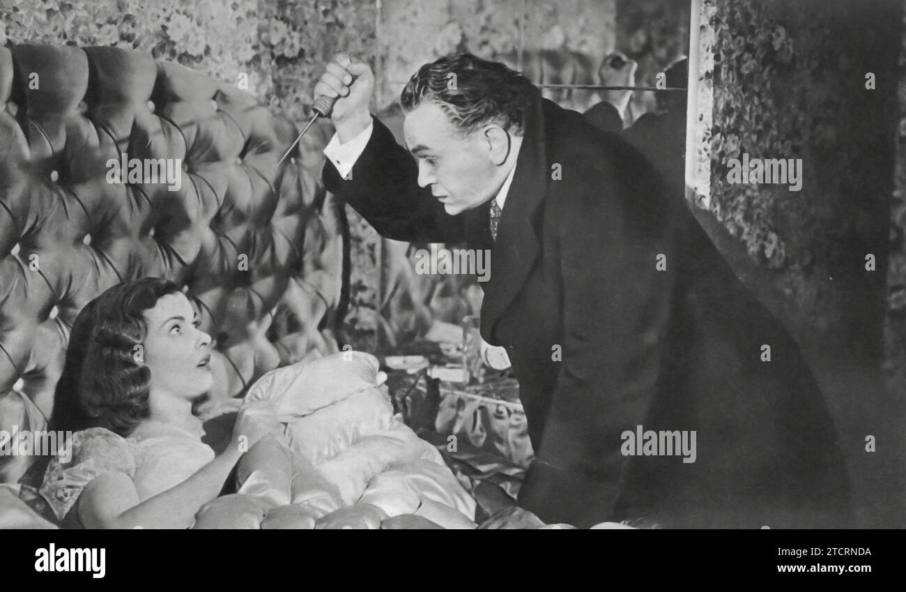 Joan Bennett et Edward G. Robinson jouent dans le film Scarlet Street de 1945. Dans ce drame noir réalisé par Fritz Lang, Bennett prend le rôle d'une femme fatale, tandis que Robinson dépeint une caissière légère et peintre amateur. Leurs chemins se croisent dans une histoire d'obsession, de tromperie et de crime. Banque D'Images