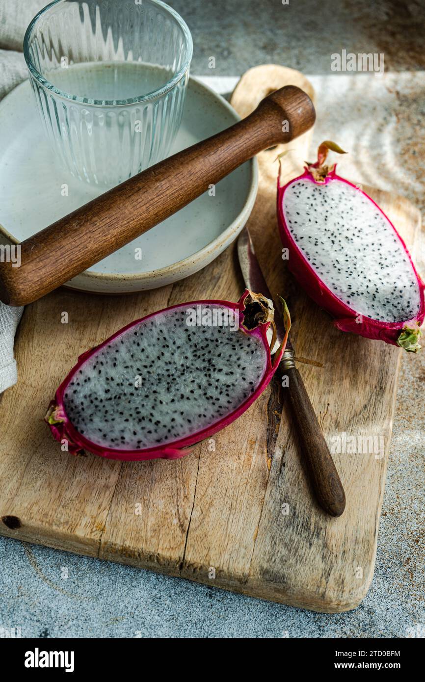 Tranché de fruits sur une planche de bois rustique avec un rouleau à pâtisserie et des plaques en céramique. Banque D'Images