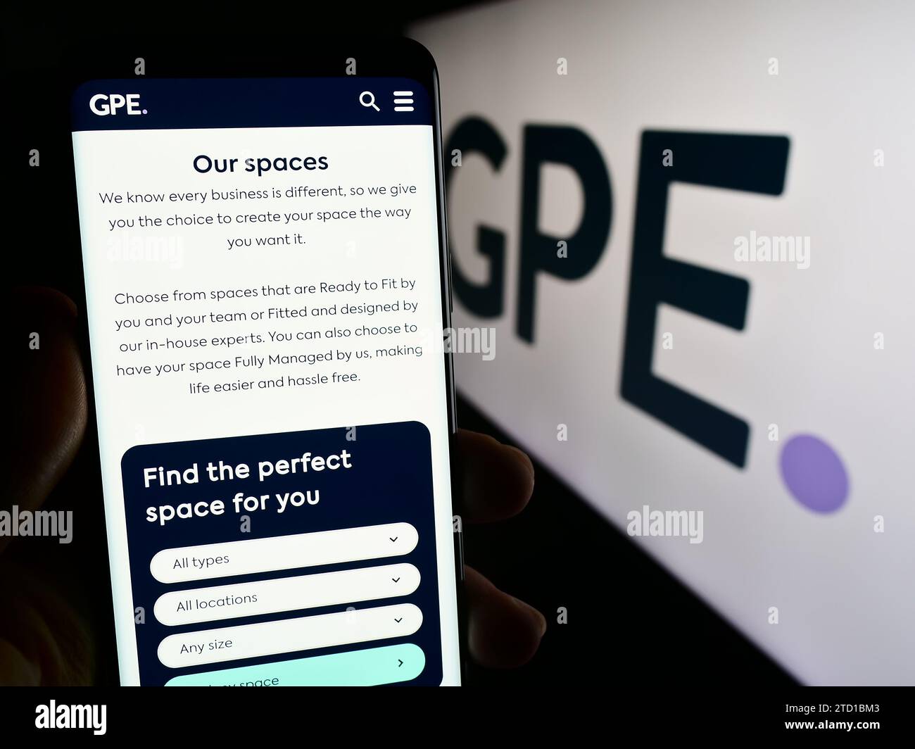 Personne tenant un smartphone avec la page Web de la société immobilière britannique Great Portland Estates plc (GPE) avec logo. Concentrez-vous sur le centre de l'écran du téléphone. Banque D'Images