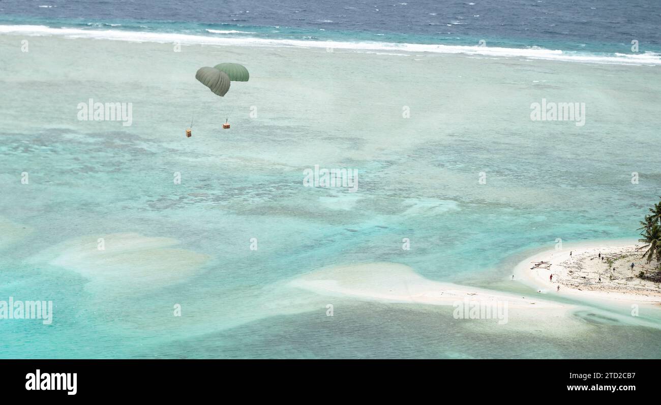 Îles Mortlock, États fédérés de Micronésie. 08 décembre 2023. Des paquets humanitaires flottent vers un lagon en parachute à partir d'un avion C-130J Super Hercules de l'US Air Force, lors de l'opération Christmas Drop, le 8 décembre 2023 dans les États fédérés de Micronésie. L’opération Christmas Drop est la plus ancienne mission humanitaire et de secours en cas de catastrophe qui fournit 71 000 livres de nourriture, de cadeaux et de fournitures pour aider les communautés insulaires éloignées du Pacifique Sud. Crédit : SRA Lauren Clevenger/US Airforce photo/Alamy Live News Banque D'Images