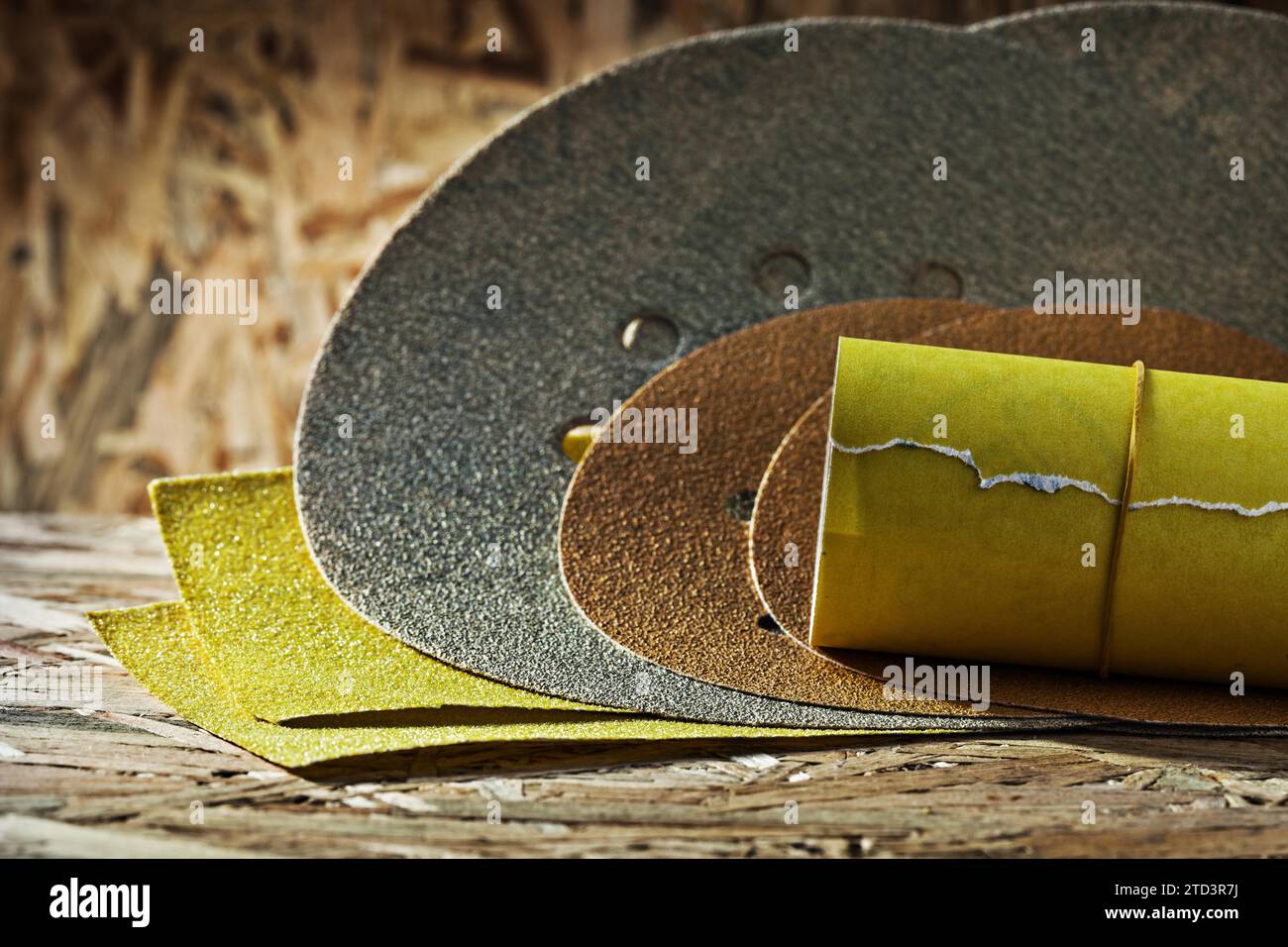 Abrasifs ronds carrés et laminés feuilles de papier de verre sur fond de contreplaqué Banque D'Images