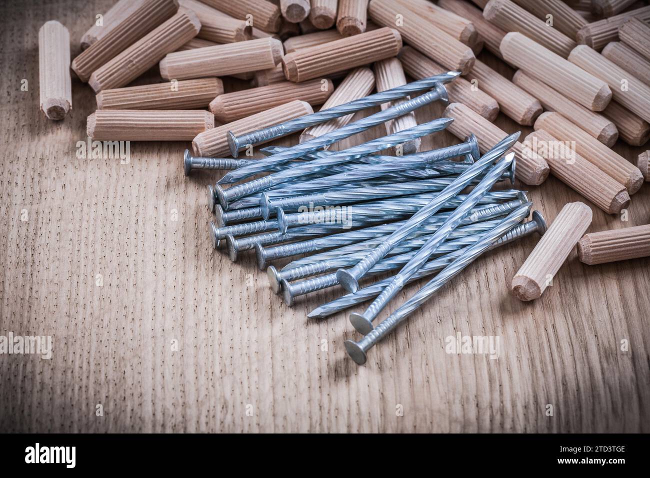 Pile de chevilles en bois construisant des clous sur fond en bois Banque D'Images