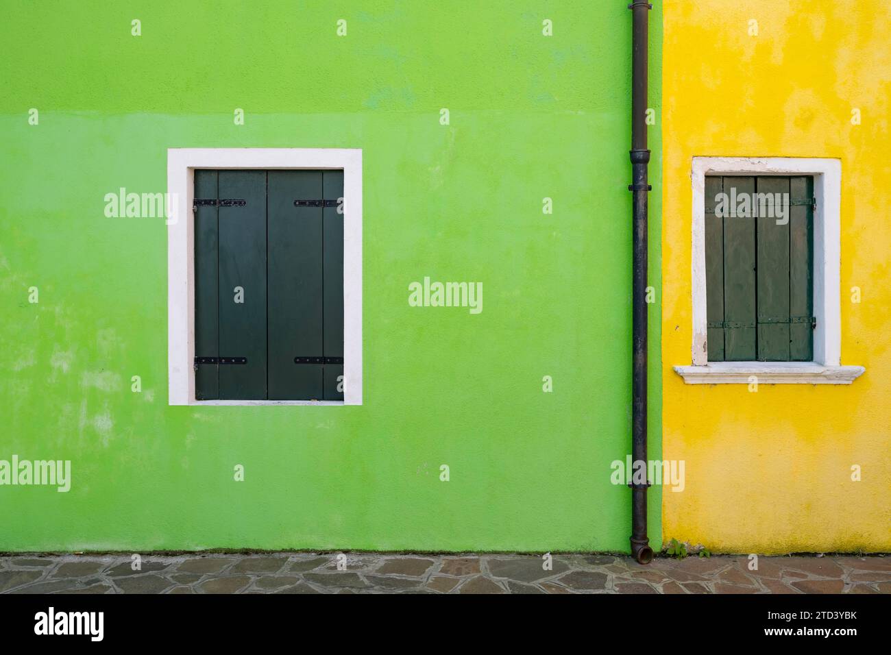 Façade de maison verte et jaune avec fenêtres avec volets fermés, maisons colorées sur l'île de Burano, Venise, Vénétie, Italie Banque D'Images