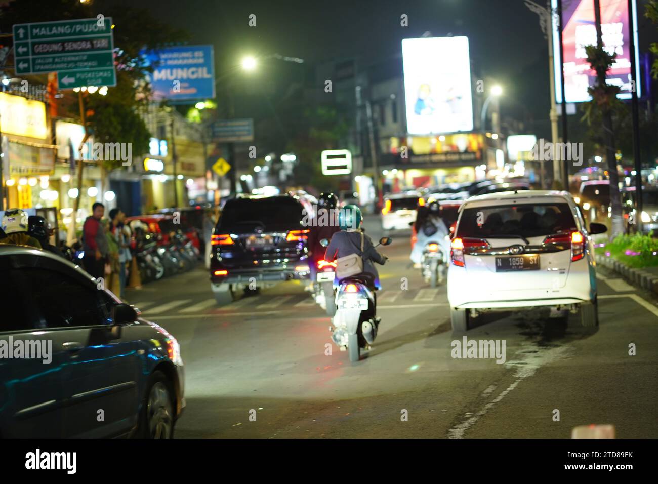 9 décembre 2023. Batu City, Java oriental, Indonésie. La vie nocturne dans la rue de la ville avec le trafic occupé le samedi soir. Banque D'Images