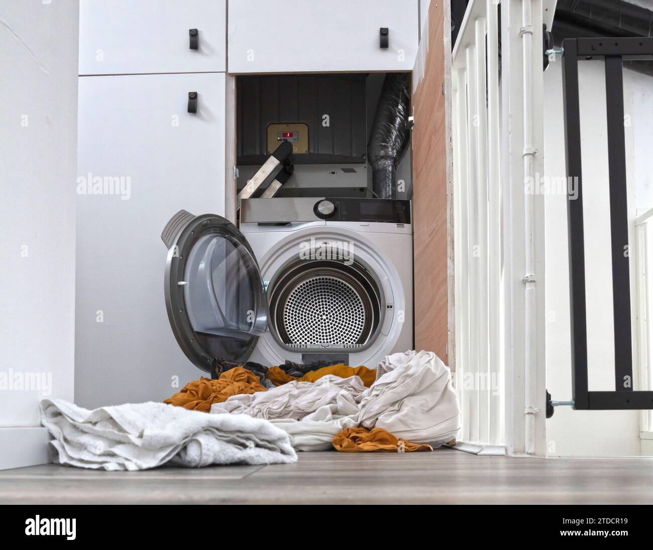Le linge sale qui s'écoule de la machine à laver et sèche-linge Banque D'Images