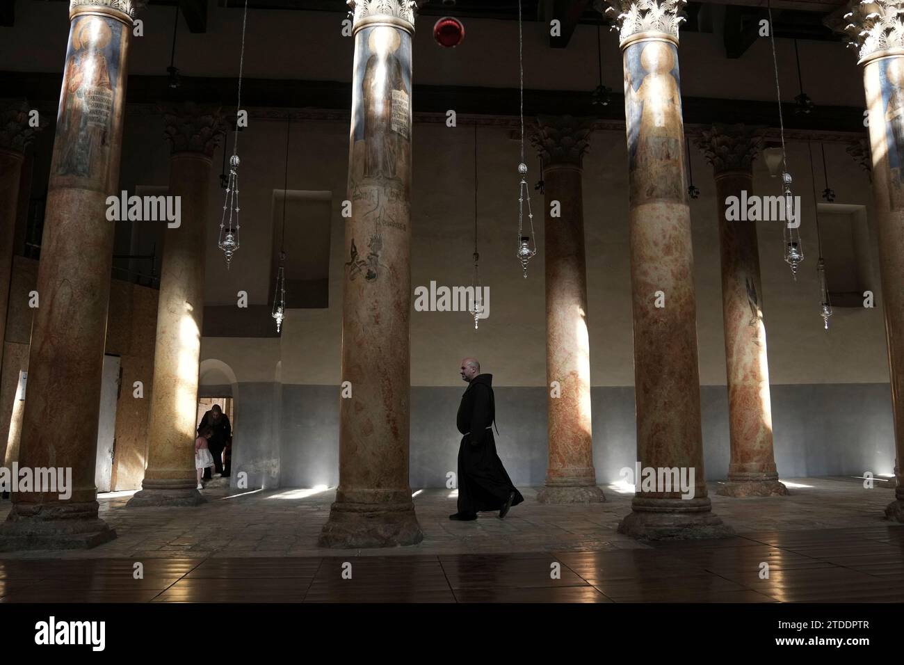A priest walks at the Church of the Nativity, traditionally believed to be the birthplace of Jesus Christ in the West Bank town of Bethlehem, Saturday, Dec. 16, 2023. World-famous Christmas celebrations in Bethlehem have been put on hold due to the ongoing Israel-Hamas war. (AP Photo/Mahmoud Illean) Banque D'Images