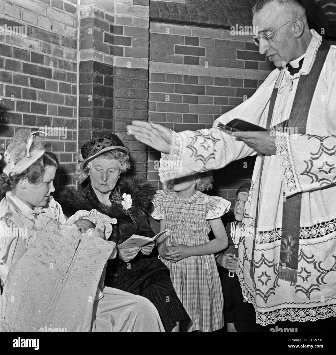 Clerc baptise bébé ca. Mai 1950 Banque D'Images