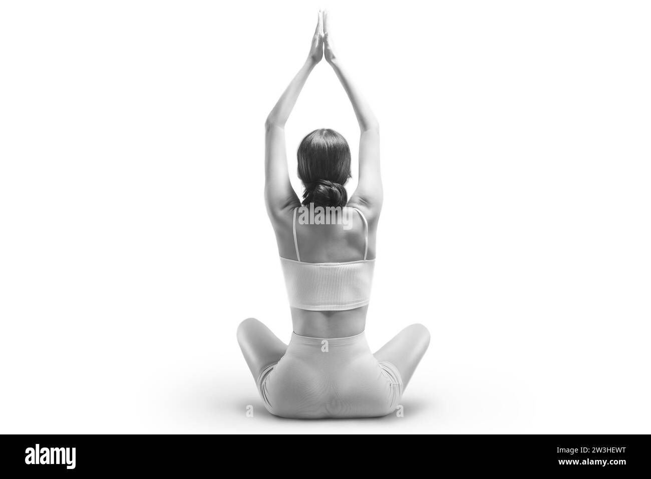 Jeune femme sportive pratiquant le yoga. Isolé sur fond blanc. Le concept d'un mode de vie sain et l'équilibre naturel entre le corps et Banque D'Images