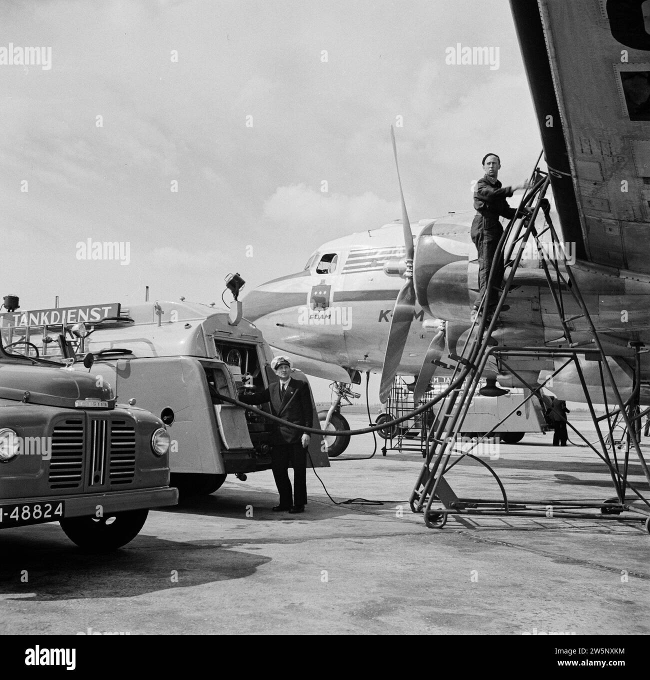 Le Douglas DC-4 Edam avec le style maison KLM et avec le logo Edam sous la fenêtre latérale du cockpit de l'aéroport de Schiphol au milieu du démarreur et des pétroliers. env. Août 1951 Banque D'Images