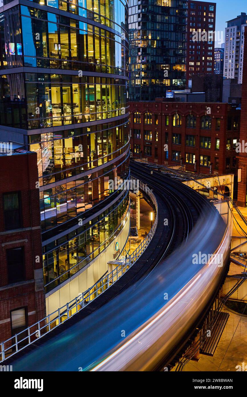 Chicago Urban Dynamic : train en mouvement, bâtiments en verre et brique au crépuscule Banque D'Images