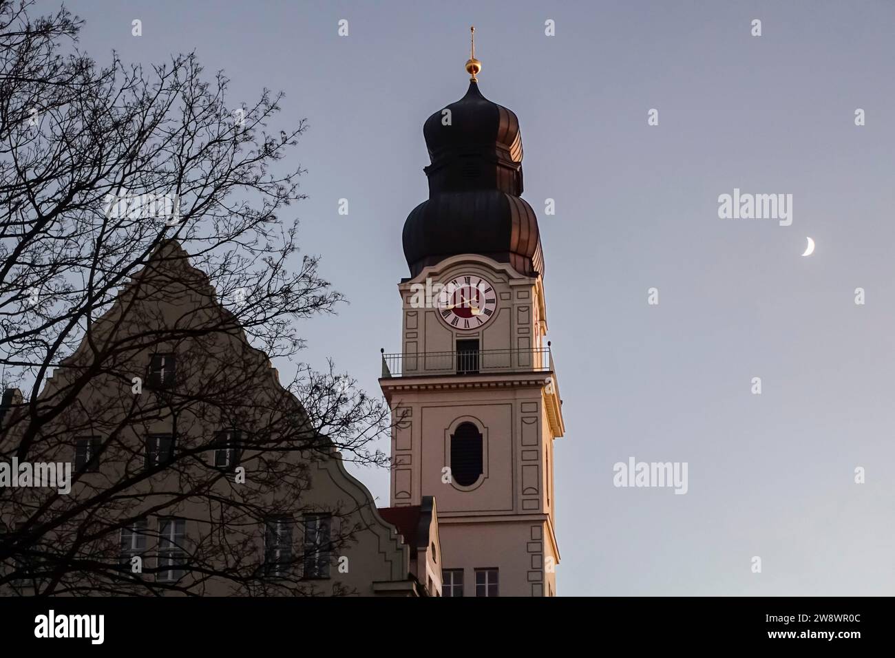 Tour de l'horloge de l'école Maria-Probst-Realschule et lune partielle au coucher du soleil à Munich-Sendling, Munich, Bavière Banque D'Images