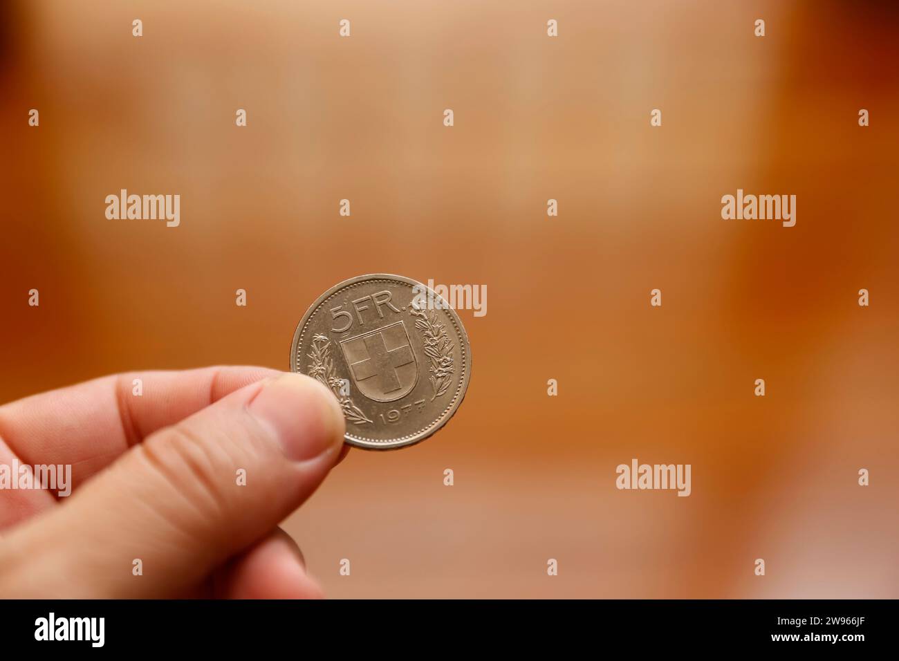 pièce suisse de cinq francs entre les doigts - pièce en franc suisse Banque D'Images