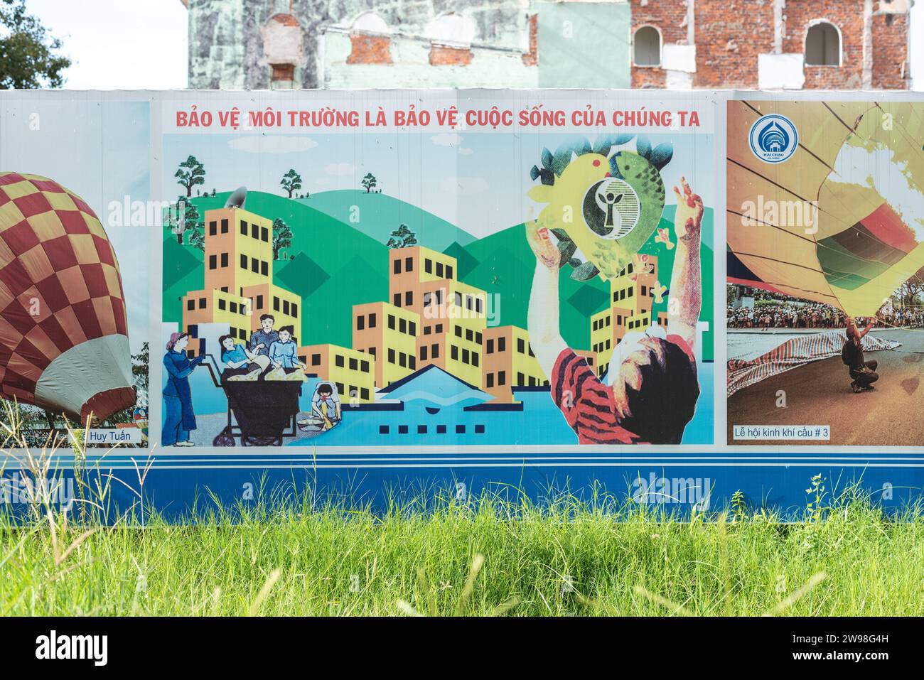 Da Nang, Vietnam - 7 octobre 2023 : une affiche "protéger l'environnement, c'est protéger nos vies" sur une clôture de construction. Banque D'Images