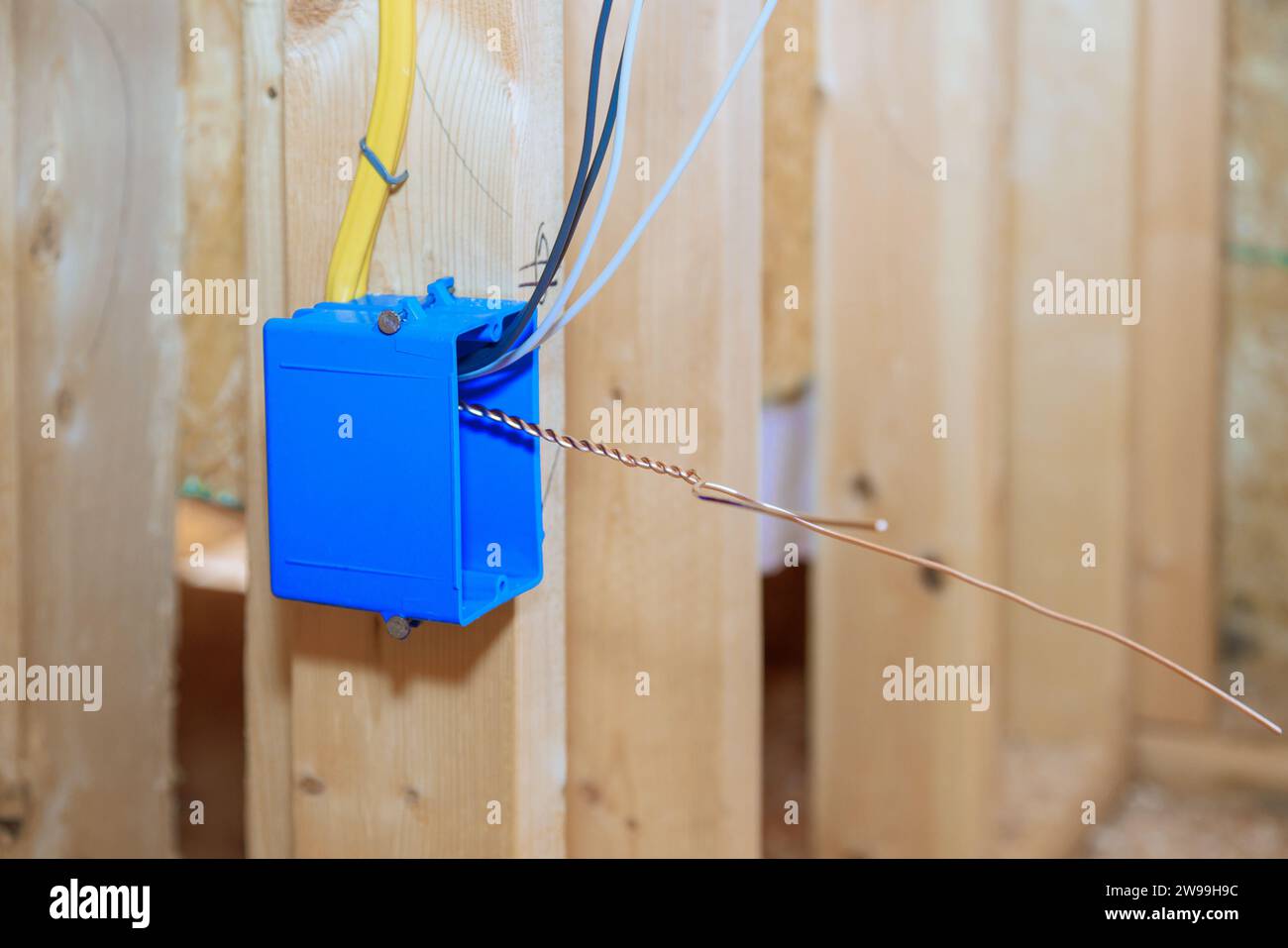 Boîte de commutation électrique en plastique avec des fils aux poutres de cadre en bois sur le mur Banque D'Images