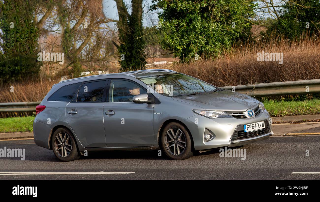 Milton Keynes, Royaume-Uni - 28 décembre 2023:2014 Toyota Auris voiture électrique hybride conduisant sur une route anglaise Banque D'Images