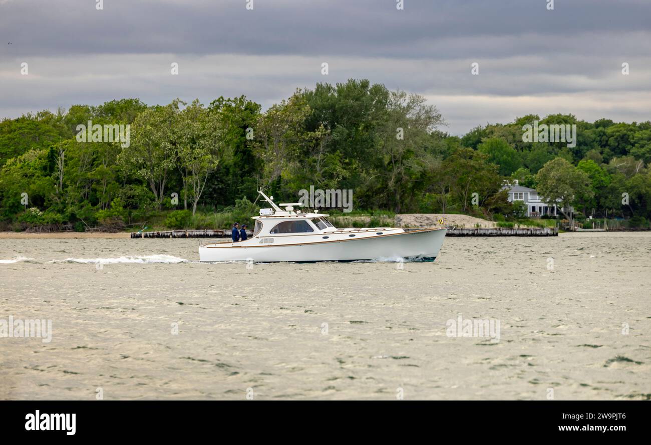 les gens naviguant dans un yacht à moteur hinckley blanc au large de la côte de l'île d'abri Banque D'Images