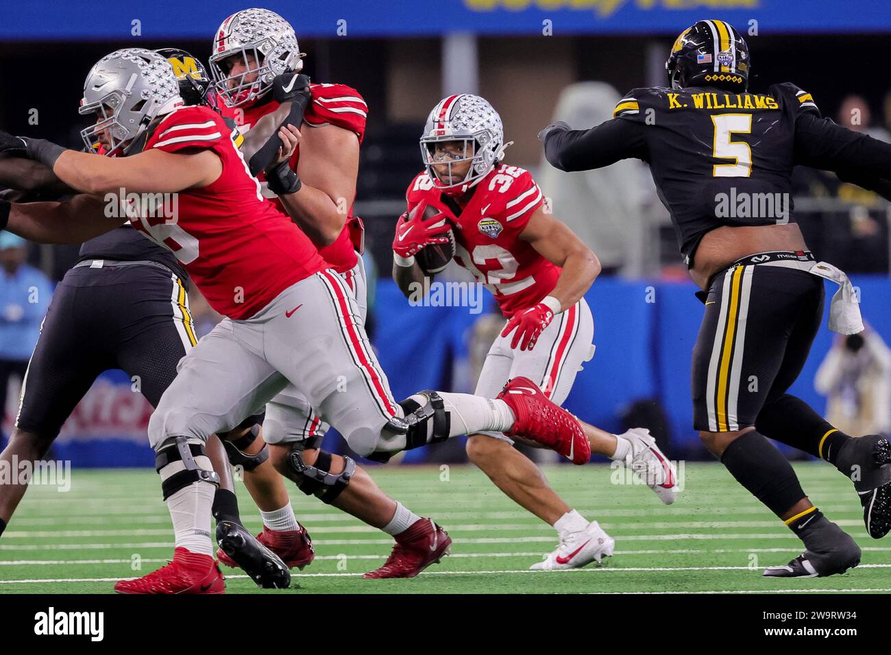 Arlington, Texas, États-Unis. 29 décembre 2023. Buckeyes de l'Ohio State TreVeyon Henderson (32 ans) porte le ballon pendant le match entre les Tigers du Missouri et les Buckeyes de l'Ohio State au AT&T Stadium, Arlington, Texas. (Image de crédit : © Scott Stuart/ZUMA Press Wire) USAGE ÉDITORIAL SEULEMENT! Non destiné à UN USAGE commercial ! Banque D'Images