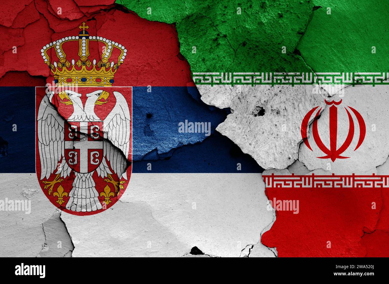 Drapeaux de Serbie et d'Iran peints sur mur fissuré Banque D'Images