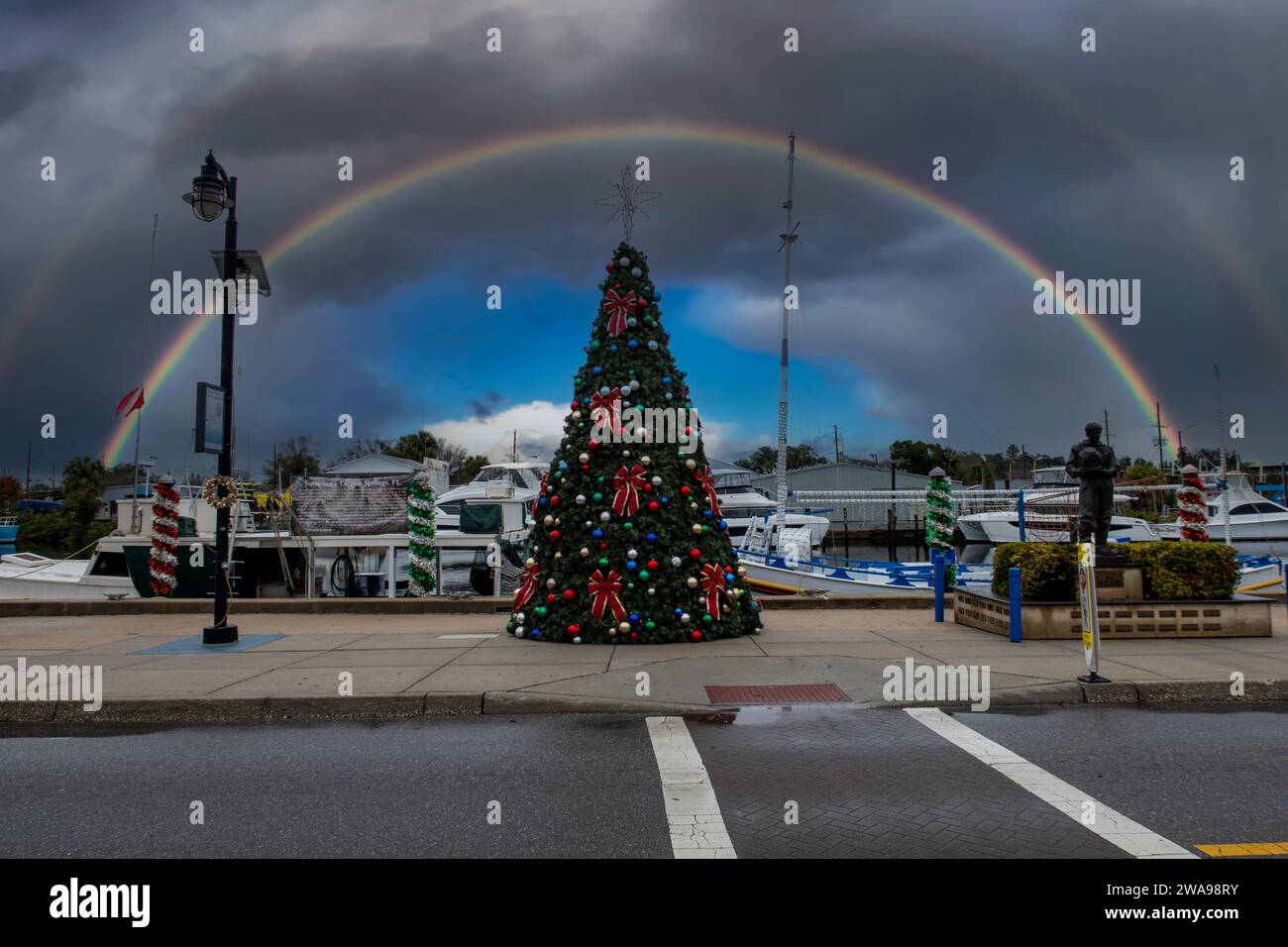 Un arc-en-ciel au-dessus du grand arbre de Noël sur les quais en éponge à Tarpon Springs, Floride, USA Banque D'Images