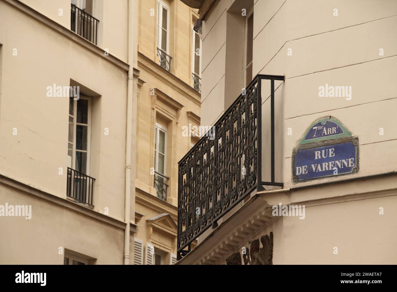 Une balustrade ornée en fer forgé noir donnant sur un bâtiment blanc avec signalisation sur le balcon à Paris, France Banque D'Images