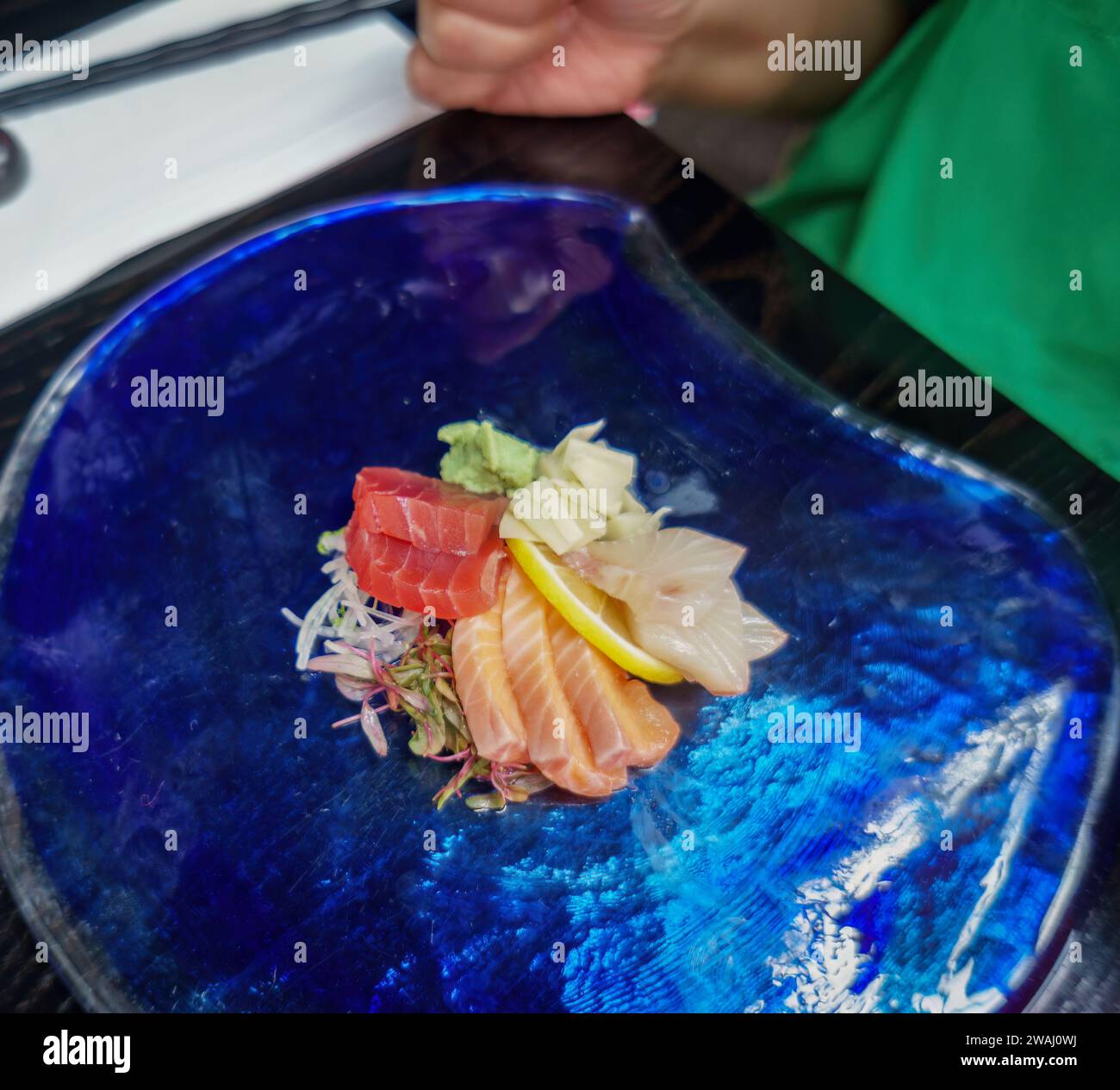 Plat de sashimi japonais sur l'assiette bleu foncé sur la table Banque D'Images